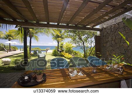 Stock Photo - Dining table on verandah outside a brazilian Beach house. . Fotosearch