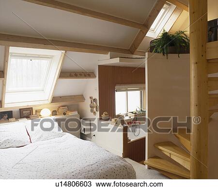 Divan bed below Velux window in attic conversion bedroom with pine staircase View Large Photo Image Stock Image - Divan bed below Velux window in attic conversion bedroom with pine staircase. Fotosearch