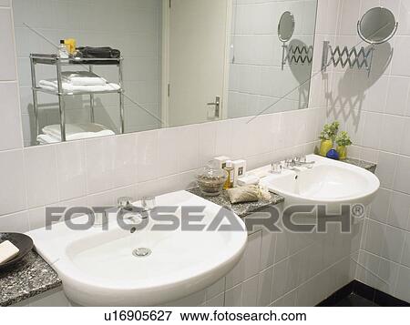 Double basins below mirror in modern white bathroom View Large Photo Image Stock Photo - Double basins below mirror in modern white bathroom. Fotosearch