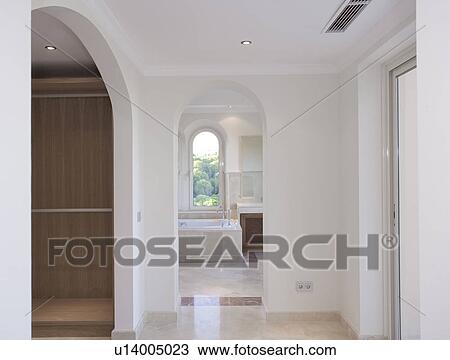Stock Image - Empty Mclundie apartment looking through to bathroom.. Fotosearch
