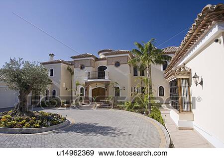 Exterior of large villa with circular driveway around an ancient olive tree. View Large Photo Image Stock Photo - Exterior of large villa with circular driveway around an ancient olive tree.. Fotosearch