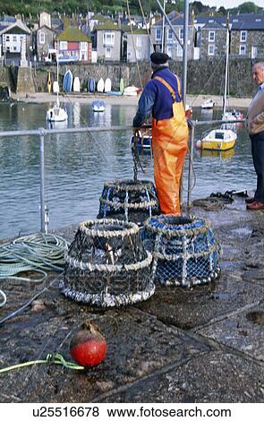 Fisherman with lobster creels on the quay at Newyln Harbour in Cornwall View Large Photo Image Stock Photo - Fisherman with lobster creels on the quay at Newyln Harbour in Cornwall. Fotosearch