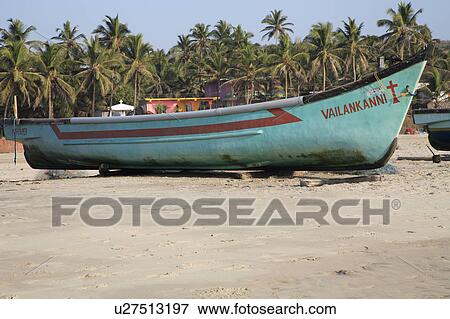 Fishing boat on blocks on the beach, backed by palm trees. View Large Photo Image Stock Photo - Fishing boat on blocks on the beach, backed by palm trees.. Fotosearch