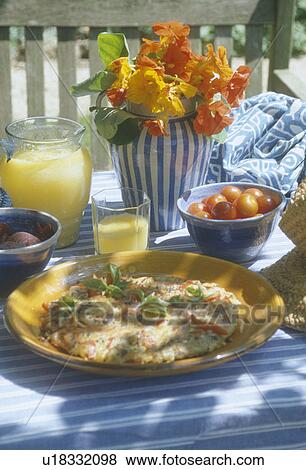 Fruit-juice in glass jug on garden table with omelette on plate and orange nasturtiums in vase View Large Photo Image Stock Photo - Fruit-juice in glass jug on garden table with omelette on plate and orange nasturtiums in vase. Fotosearch