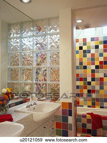 Glass brick dividing wall in modern bathroom with multcoloured wall tiles View Large Photo Image Stock Photo - Glass brick dividing wall in modern bathroom with multcoloured wall tiles. Fotosearch