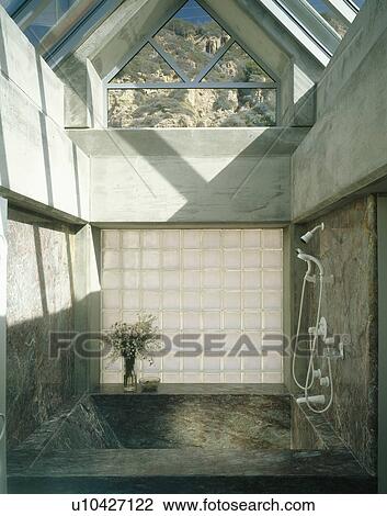 Glass brick wall above bath with enclosed granite walls in architectural bathroom View Large Photo Image Stock Image - Glass brick wall above bath with enclosed granite walls in architectural bathroom. Fotosearch