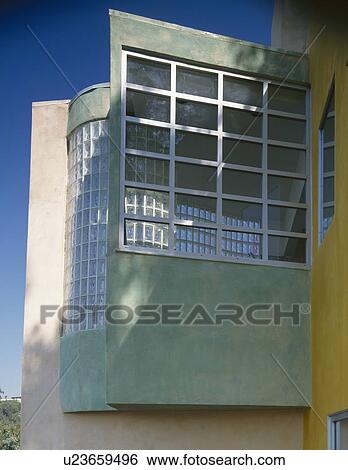 Stock Photograph - Glass brick wall and large window in modern architectural house. Fotosearch