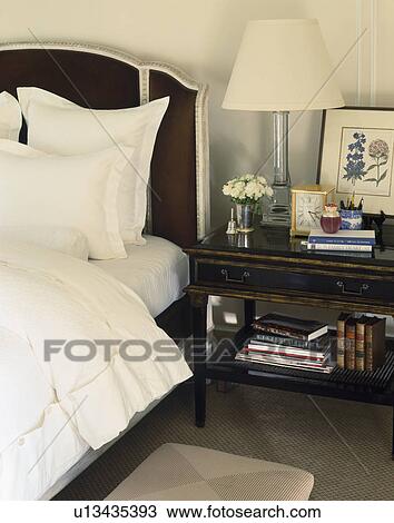 Verwonderend Glass lamp and books on antique table beside bed with white GC-38