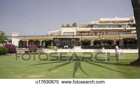 Golf course with hotel in background. View Large Photo Image Stock Photography - Golf course with hotel in background.. Fotosearch