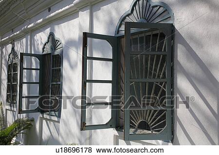 Stock Photo - Green painted casement windows with security grills.. Fotosearch