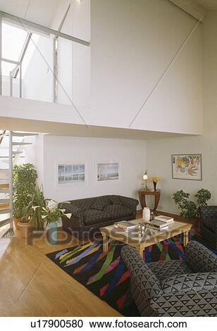 Grey sofas and wooden flooring in modern loft conversion living room View Large Photo Image Stock Image - Grey sofas and wooden flooring in modern loft conversion living room. Fotosearch