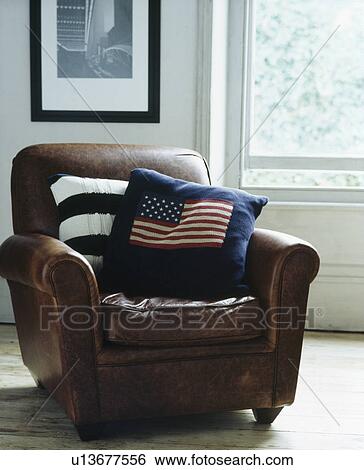 Knitted stars+stripes cushion on old brown leather armchair View Large Photo Image Stock Photograph - Knitted stars+stripes cushion on old brown leather armchair. Fotosearch