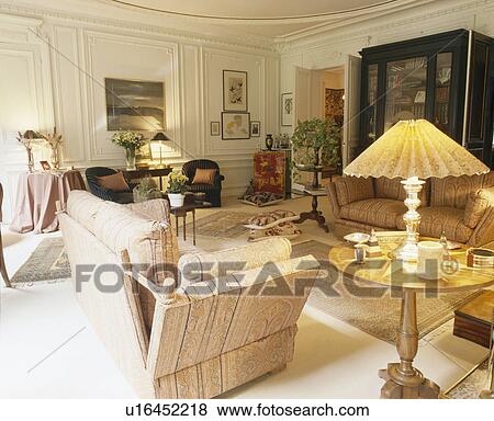 Knole sofa in French townhouse living room with lighted lamp on small table View Large Photo Image Stock Photo - Knole sofa in French townhouse living room with lighted lamp on small table. Fotosearch