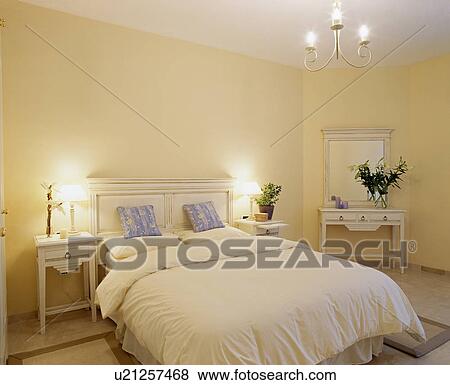 Lamps on either side of bed with white linen View Large Photo Image Stock Photo - Lamps on either side of bed with white linen . Fotosearch
