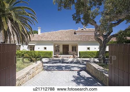 Stock Photo - Large detached villa sounded by gardens.. Fotosearch