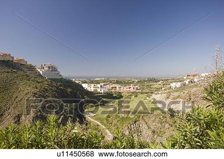 Stock Photo - Large gardens in front of the villas from above.. Fotosearch