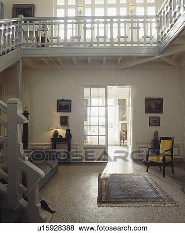 Stock Photo - Large grey traditional hall with gallery landing and terrazzo floor. Fotosearch
