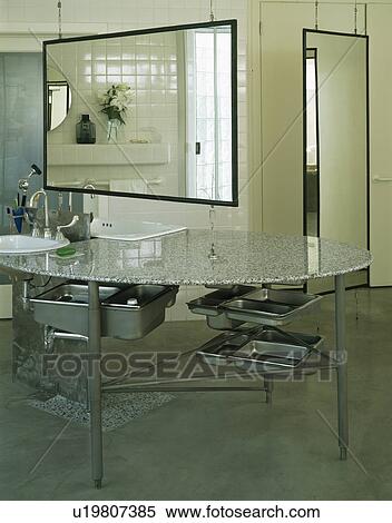 Large mirror above steel vanity unit with stainless-steel storage trays View Large Photo Image Stock Photography - Large mirror above steel vanity unit with stainless-steel storage trays. Fotosearch