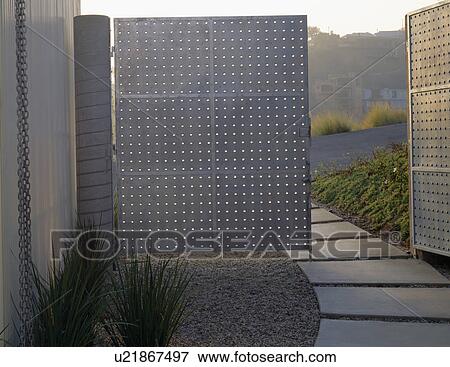 Large modern doors in Californian garden with concrete paved path View Large Photo Image Stock Photo - Large modern doors in Californian garden with concrete paved path. Fotosearch