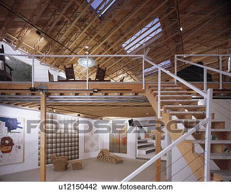 Large modern hall with open-tread staircase to mezzanine living area in house designed by Brian Murphy View Large Photo Image Stock Image - Large modern hall with open-tread staircase to mezzanine living area in house designed by Brian Murphy. Fotosearch