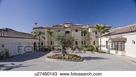 Large villa in Southern Spain with circular driveway around ancient olive tree. View Large Photo Image Stock Image - Large villa in Southern Spain with circular driveway around ancient olive tree.. Fotosearch
