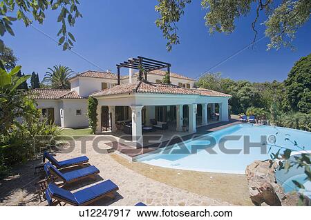 Large villa with area outside and large swimming pool View Large Photo Image Stock Photo - Large villa with area outside and large swimming pool. Fotosearch