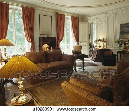 Lighted lamps and comfortable sofas in country drawing room View Large Photo Image Stock Image - Lighted lamps and comfortable sofas in country drawing room. Fotosearch