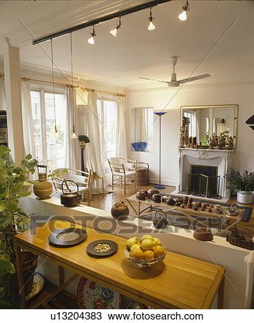 Lighting above table beside half-wall dividing French townhouse living room View Large Photo Image Stock Image - Lighting above table beside half-wall dividing French townhouse living room. Fotosearch