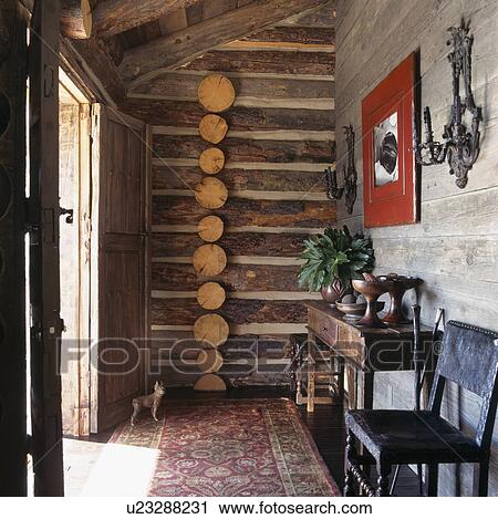 Stock Image - Log panelled wall in small rustic hall. Fotosearch