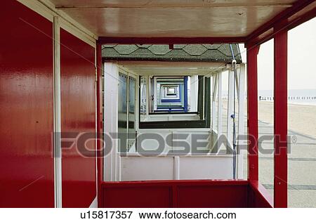 Stock Photo - Looking through verandas of a row of beach huts at Southwold in Suffolk. Fotosearch