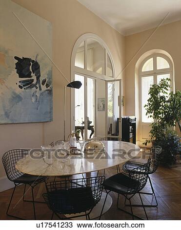 Marble-topped table and black metal chairs in townhouse dining room View Large Photo Image Stock Image - Marble-topped table and black metal chairs in townhouse dining room. Fotosearch