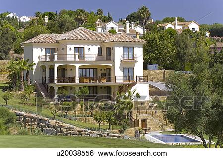 Stock Photograph - Mclundie villa built into sloping site with pool in front.. Fotosearch
