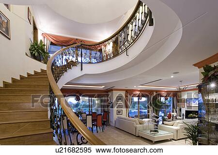 Mclundie villa with grand staircase sweeping up from the openplan livingroom. View Large Photo Image Stock Photography - Mclundie villa with grand staircase sweeping up from the openplan livingroom.. Fotosearch