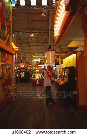 Men playing the slot machines at Amusement Arcade at Weston Super Mare in Somerset View Large Photo Image Stock Image - Men playing the slot machines at Amusement Arcade at Weston Super Mare in Somerset. Fotosearch