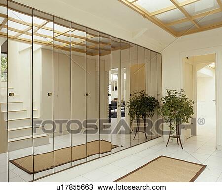 Stock Image - Mirror glass wall in modern white hall. Fotosearch