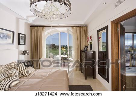 Picture - Modern bedroom with open glazed windows onto terrace.. Fotosearch