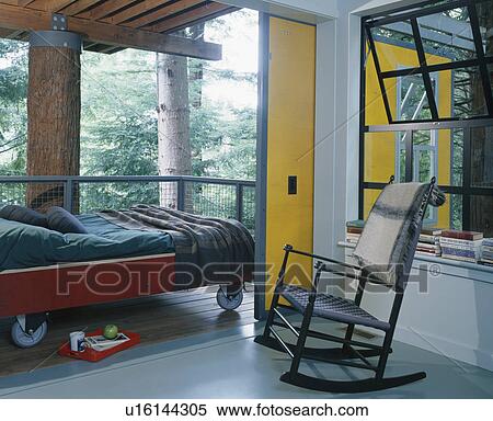 Stock Photography - Modern bedroom with rocking-chair on balcony. Fotosearch