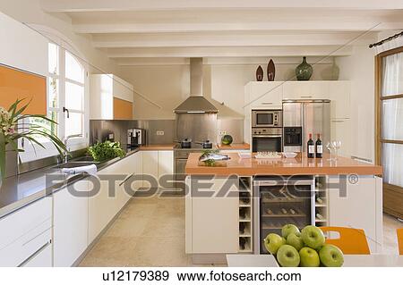 Stock Photo - Modern kitchen with island unit storing wine.. Fotosearch