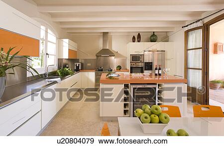 Modern kitchen with large island unit providing wine storage. View Large Photo Image Stock Photo - Modern kitchen with large island unit providing wine storage.. Fotosearch