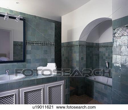 Stock Image - Modern Spanish bathroom with green wall tiles. Fotosearch