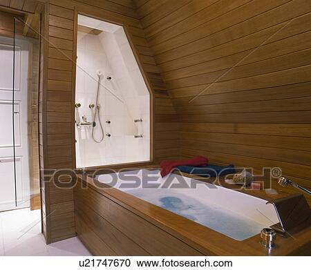 Stock Image - Modern wooden panelling attic bathroom . Fotosearch
