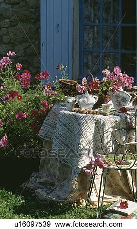 Stock Photo - Old china on circular table with quilted cloth. Fotosearch