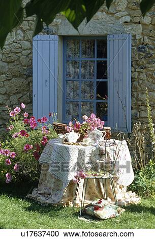 Old quilts used as cloths on circular table in front of blue shutters View Large Photo Image Stock Image - Old quilts used as cloths on circular table in front of blue shutters. Fotosearch