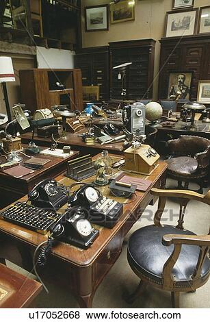 Old telephones and office equipment displayed on desks at indoor market in France View Large Photo Image Stock Photo - Old telephones and office equipment displayed on desks at indoor market in France. Fotosearch