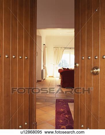 Open double wooden doors with view of modern Spanish hall View Large Photo Image Stock Photography - Open double wooden doors with view of modern Spanish hall. Fotosearch