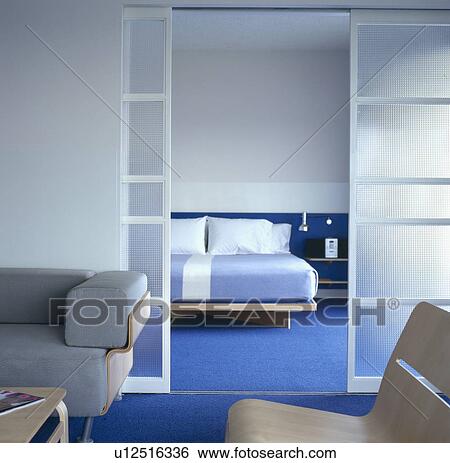 Open glass doors to bedroom with blue carpet in modern suite at The Standard Hotel in Los Angeles View Large Photo Image Stock Photograph - Open glass doors to bedroom with blue carpet in modern suite at The Standard Hotel in Los Angeles. Fotosearch