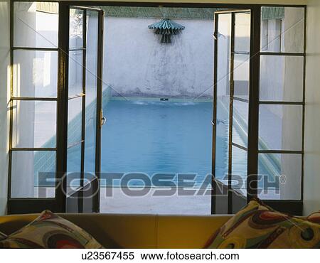 Open glass doors with view of swimming pool View Large Photo Image Stock Photography - Open glass doors with view of swimming pool. Fotosearch