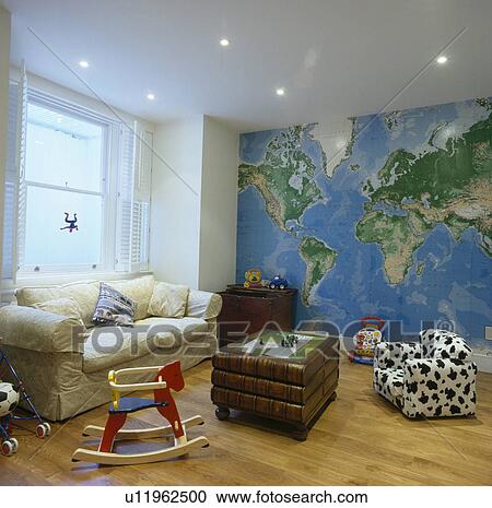Painted map of the world mural on wall of family living room with child's wooden rocking horse and animal-print chair View Large Photo Image Stock Image - Painted map of the world mural on wall of family living room with child's wooden rocking horse and animal-print chair. Fotosearch