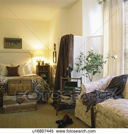 Paisley throw on folding screen in comfortable bedroom with bamboo shelves View Large Photo Image Stock Photography - Paisley throw on folding screen in comfortable bedroom with bamboo shelves. Fotosearch
