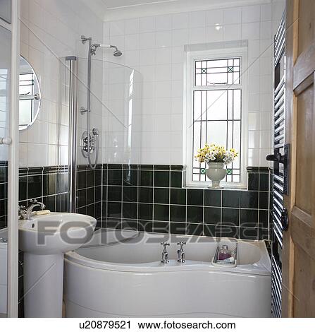 Pedestal basin beside bath with glass screen on shower in modern black+white tiled bathroom View Large Photo Image Stock Image - Pedestal basin beside bath with glass screen on shower in modern black+white tiled bathroom. Fotosearch